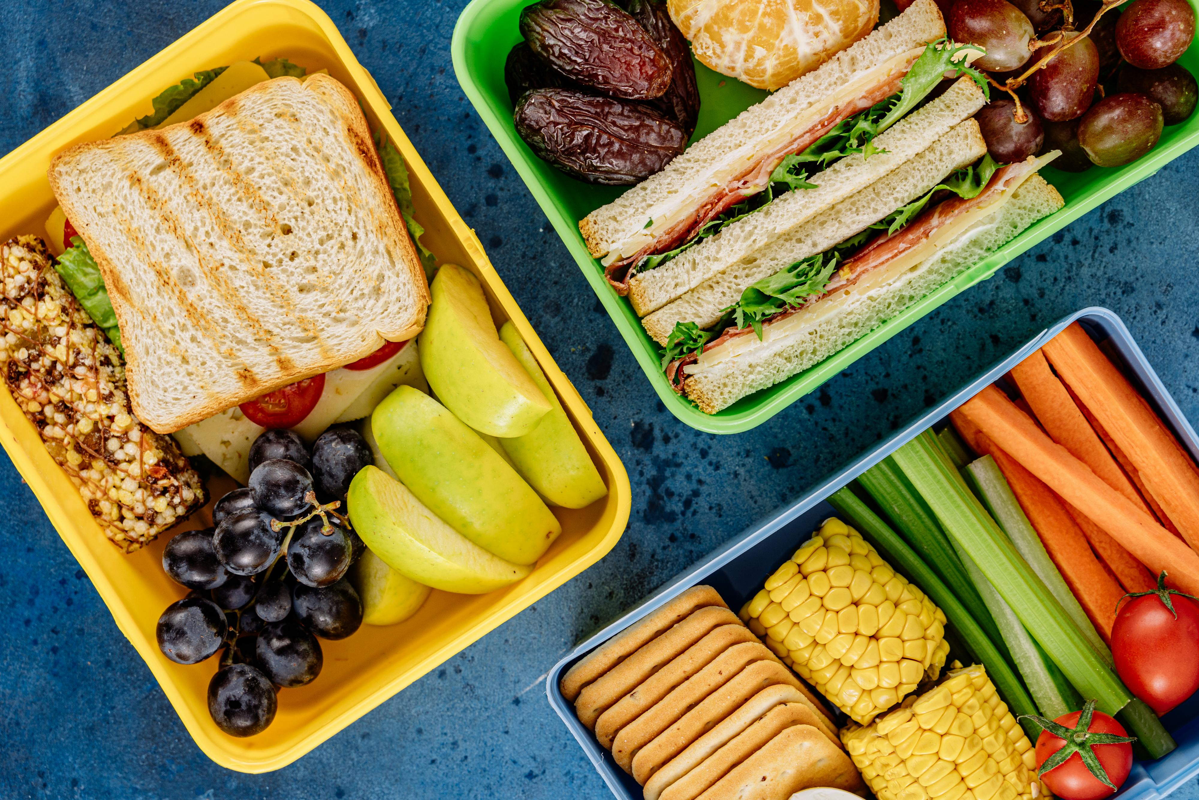 sandwiches and fruit in a packed lunch