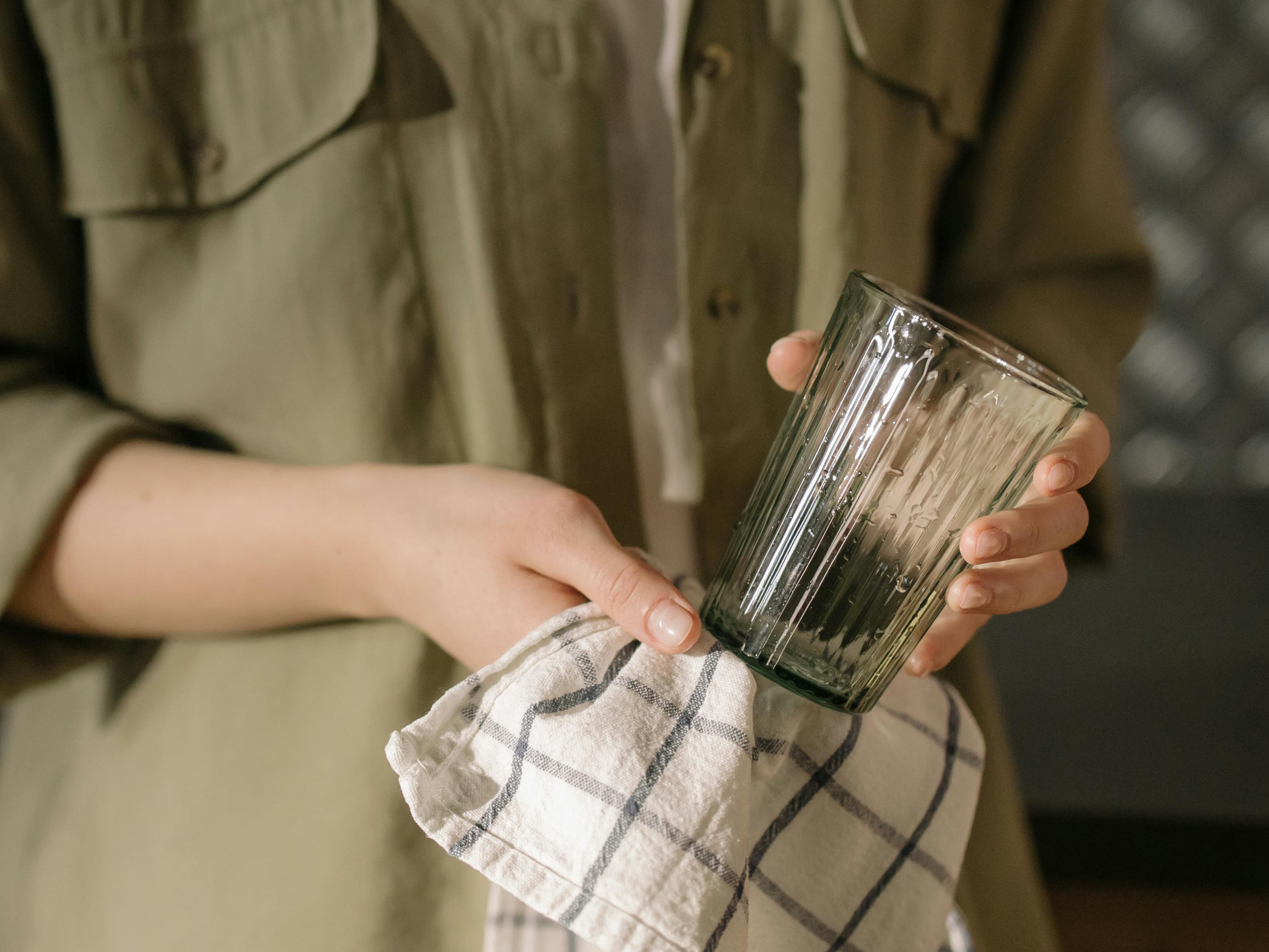 a woman holding a rinsed glass