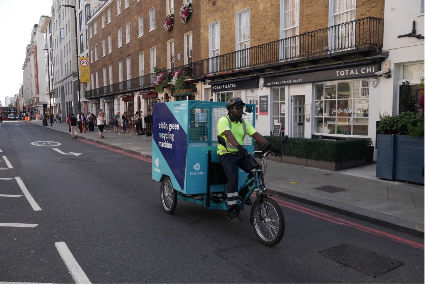 Street view of Baker Street with a man on a first mile collection bike