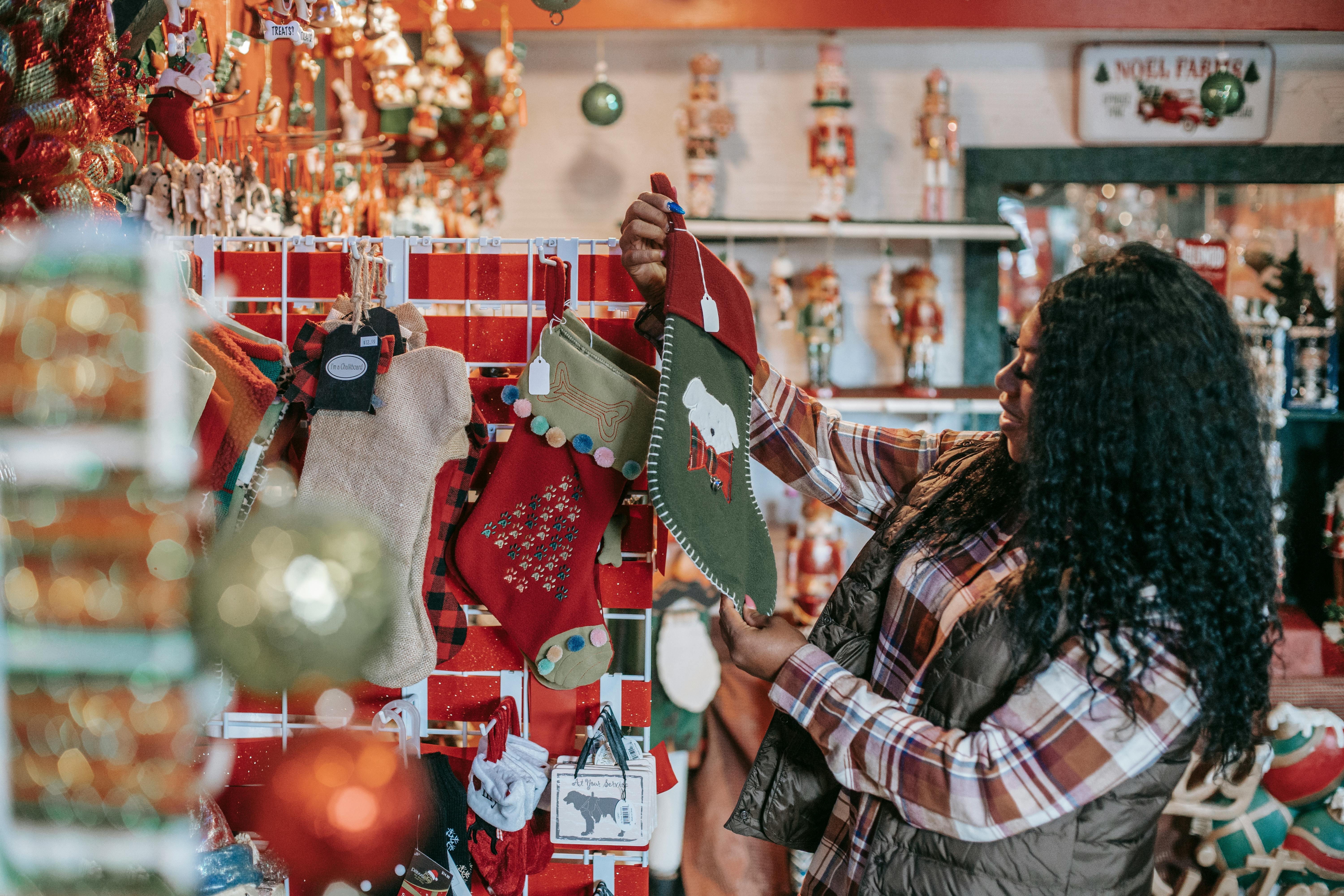 Smiling woman choosing Christmas decorations in store